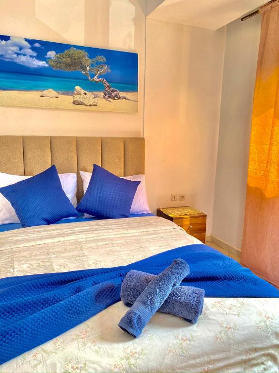 a bed with blue sheets and two towels on it at Agadir City Appartement in Agadir