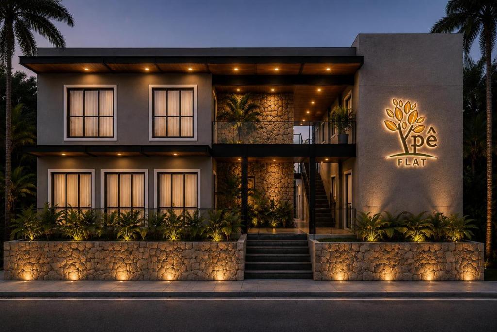 a house with a lit up sign on the side of it at Ypê Flats e Containers in Bonito