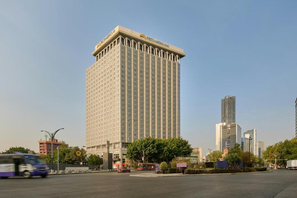 a tall building in a city with a street at Fiesta Americana Reforma in Mexico City