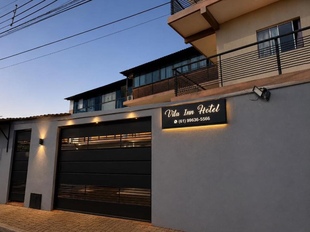 a building with a garage with a sign on it at Vila inn hotel in Brasília