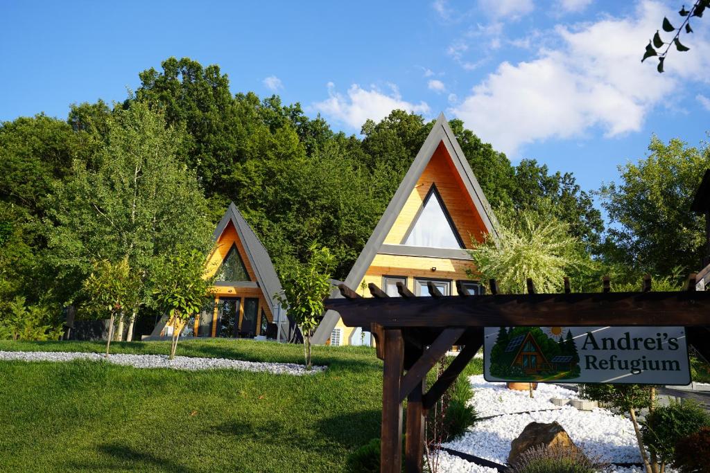 a house with a sign in front of it at Andrei's Refugium in Ocnele Mari