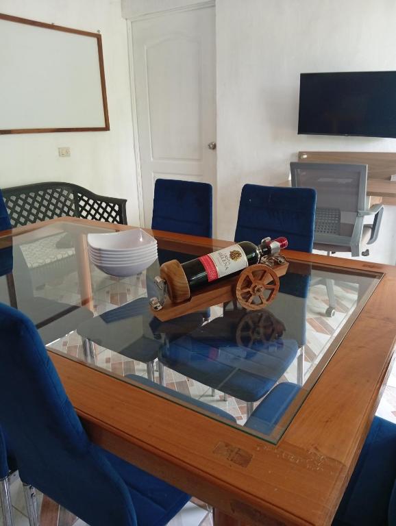 a glass table with a bottle of wine on it at Paz y Libertad in San Pedro Mártir
