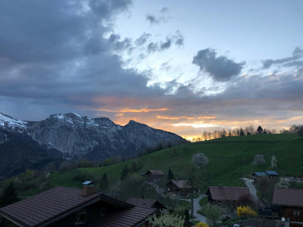 a sunset over a village in a valley with mountains at Chalet edelweiss in Les Clefs