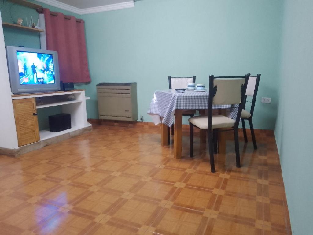 a dining room with a table and a television at Los abuelos 28 in Estación La Dorotea