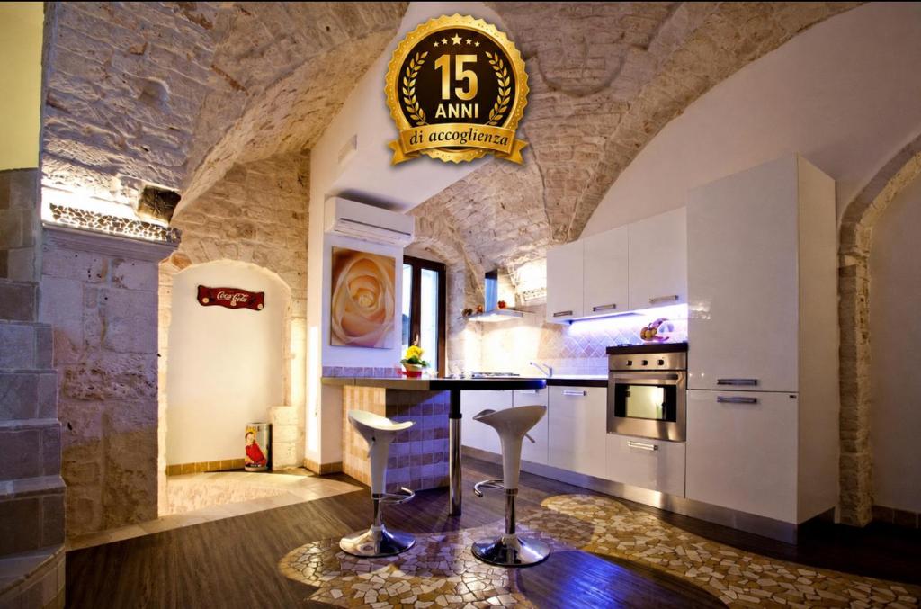 a kitchen with a large clock on the wall at L'Angolo di Gaudì, casa Milà in Putignano