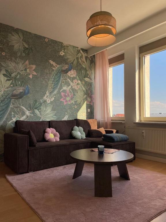 a living room with a couch and a coffee table at Panoramablick am Theaterplatz stilvolle Wohnung in Chemnitz
