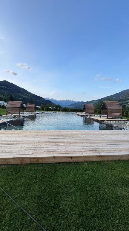 a large body of water with a dock and buildings at Appartements Wieshof in Sankt Johann im Pongau
