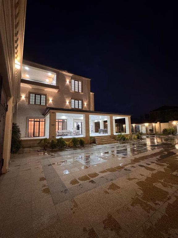 a large building at night with its lights on at Villa in Baku