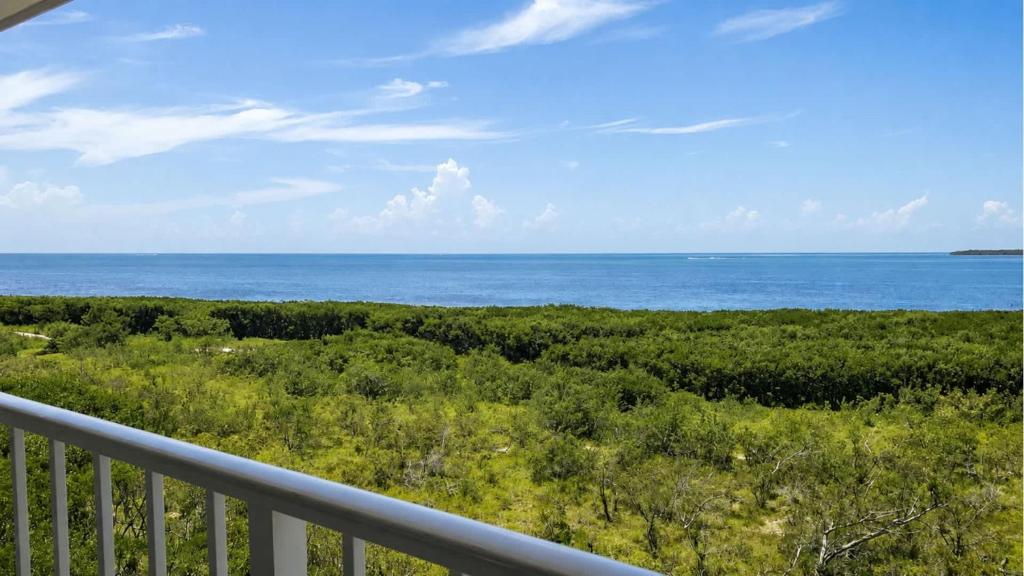 a view of the ocean from a balcony at Key Largo 2BR 2BA Oceanfront with Pool in Tavernier