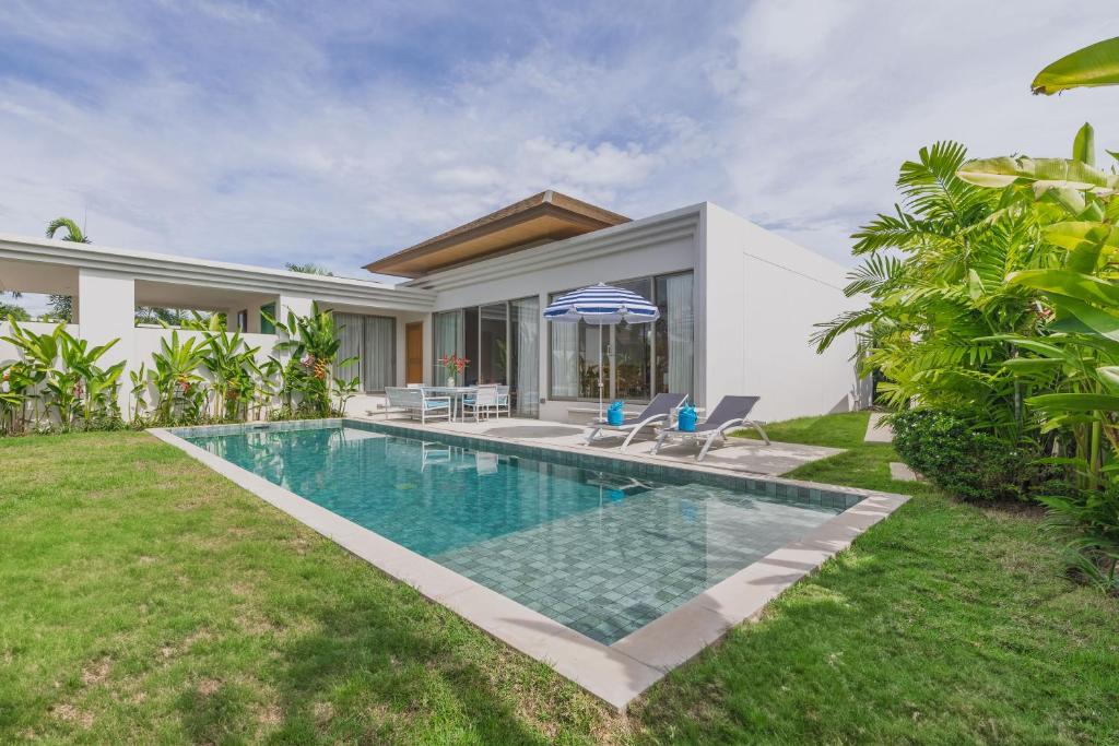 a swimming pool in the backyard of a house at Luxury 3-Bedroom private pool villa Trichada Breeze in Phuket