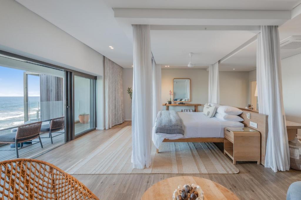 a bedroom with a bed and a view of the ocean at Sala Beach House in Ballito