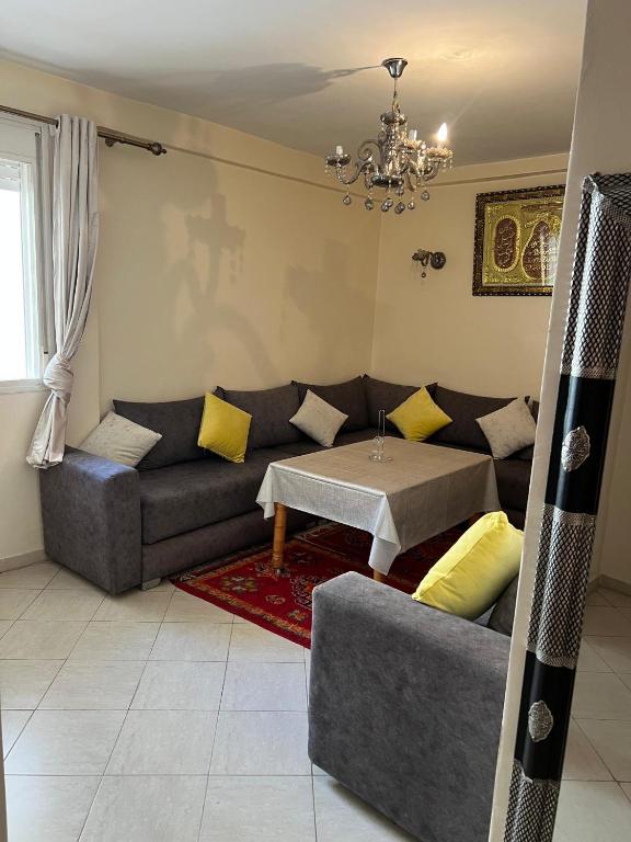 a living room with a couch and a table at Appartement Pour Vacances in Agadir