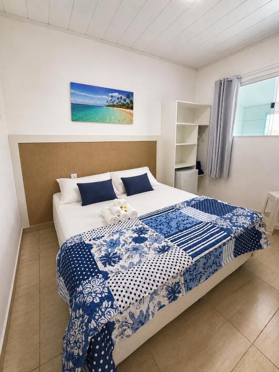 a bedroom with a bed with a teddy bear on it at Pousada Maragobeach Suits in Maragogi
