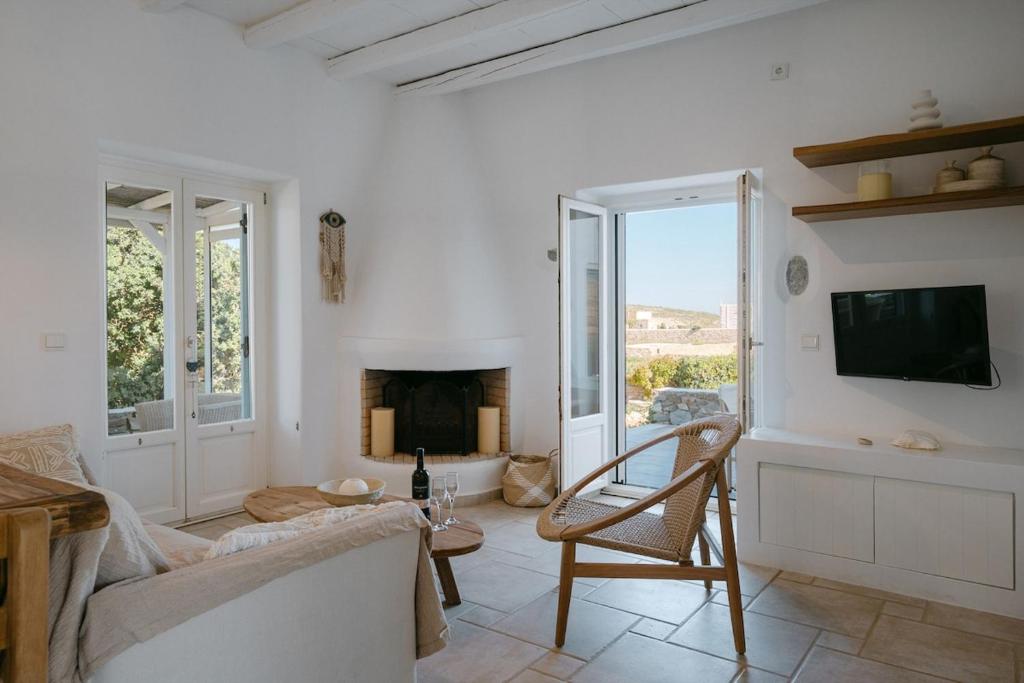 a living room with a couch and a fireplace at Casa Elia in Sarakíniko