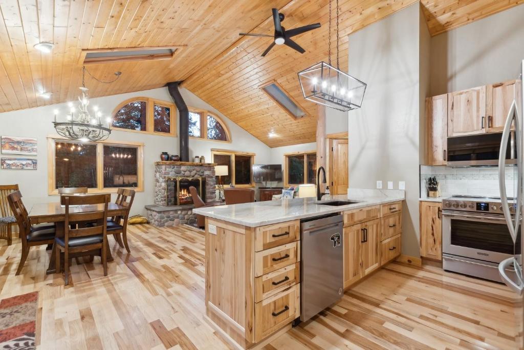 a kitchen and dining room with a table and a fireplace at Whispering Pines in Whitefish