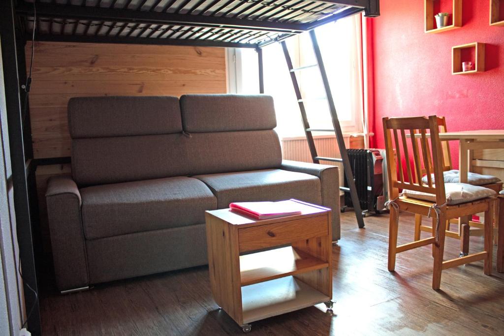 a living room with a couch and a loft bed at Appartement Superdevoluy Le Petit Suisse in Le Dévoluy