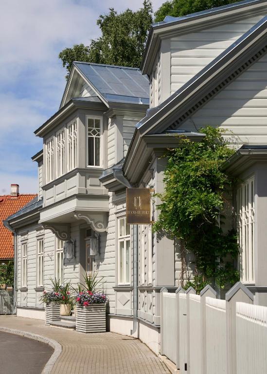 a white building with a sign in front of it at Hans Hubert Villa in Haapsalu