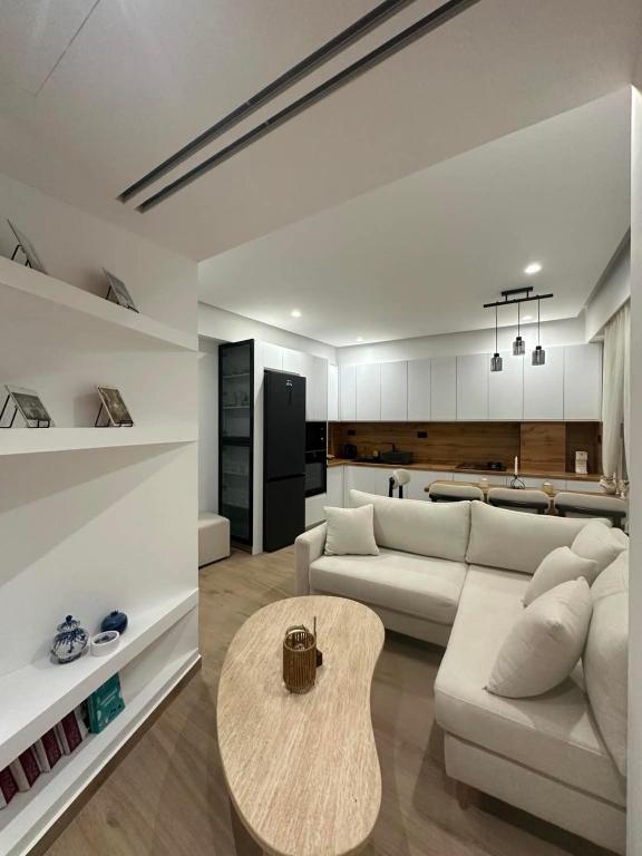a living room with a white couch and a table at Aelio apartment in Ermoupoli