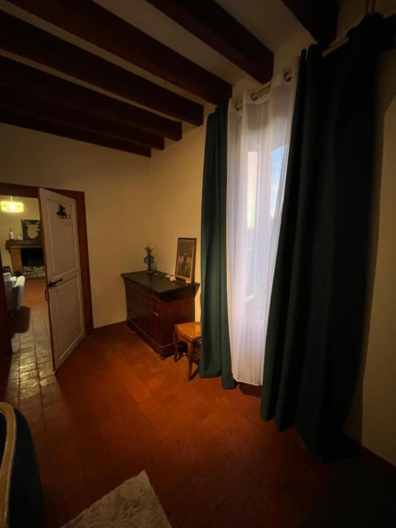 a living room with a window and a dresser at Maison solognotte in Sainte-Montaine