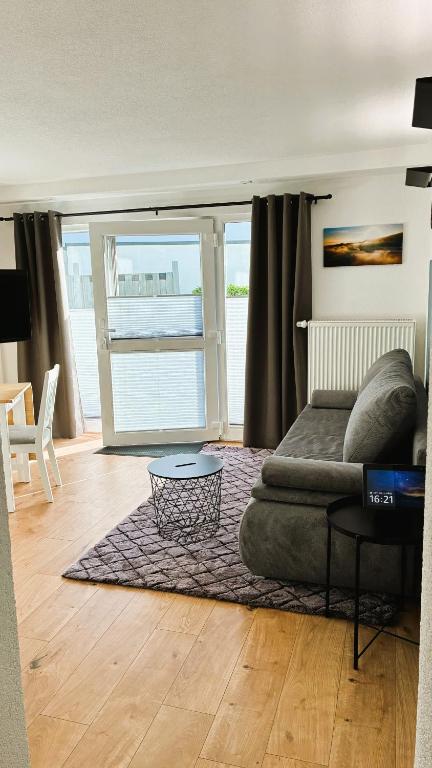 a living room with a couch and a table at Ferienwohnung Hortwald am Schaumberg in Tholey