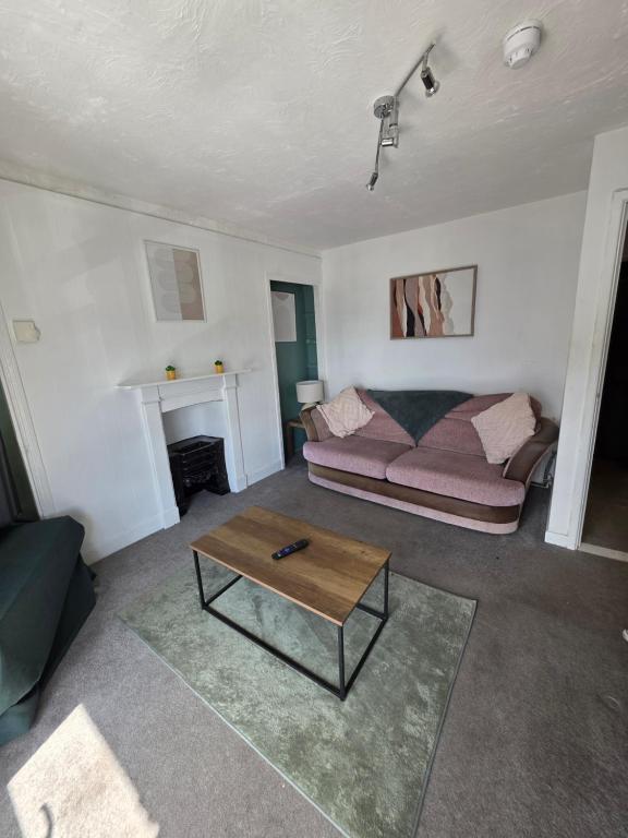 a living room with a couch and a coffee table at Horizon Hideaway in Swansea