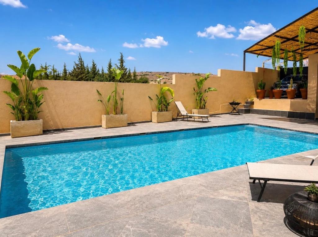 a swimming pool on top of a house at Villa Oumnass, Marrakech in Oumnas