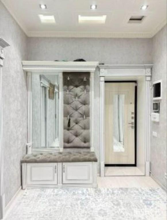 a white cabinet in a room with at Madigul in Andijan