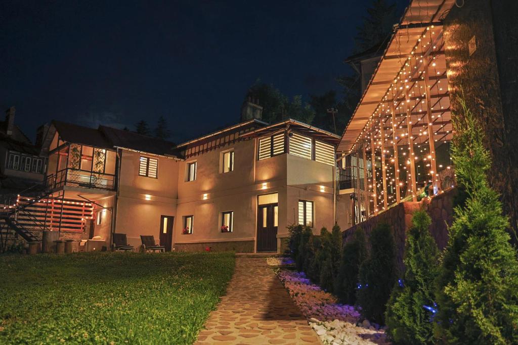 a large house with lights on the side of it at Casa SEMA in Sinaia