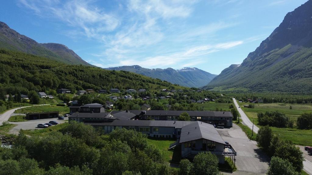 an aerial view of a village in a valley with mountains at Birtavarre Aurora Adventures in Birtavarre