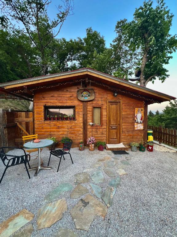 a log cabin with a table and a patio at RVilla in Pavliani