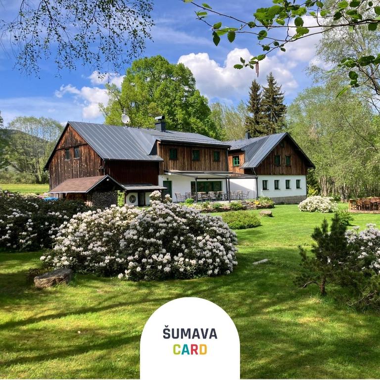 a house on a green lawn with the words simiyaard at Chata Rozhlas in Železná Ruda