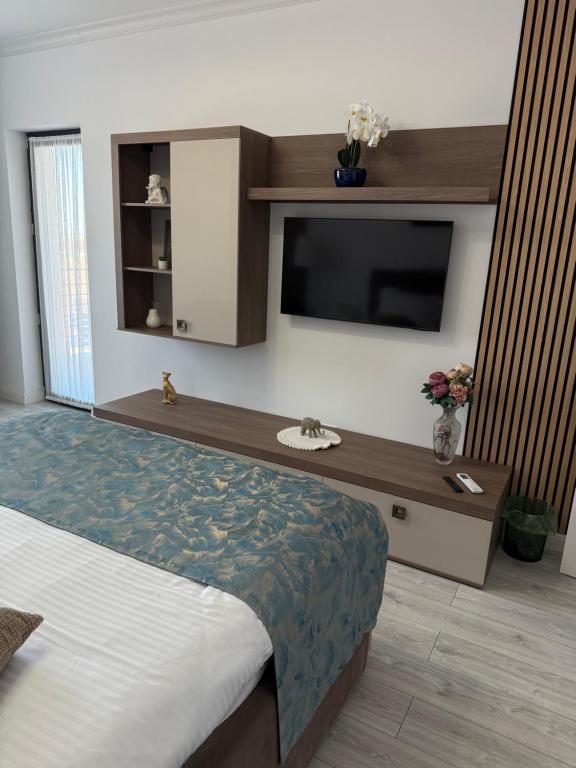 a bedroom with a tv and a bed with a bed sidx sidx sidx at Day Studio in Focşani