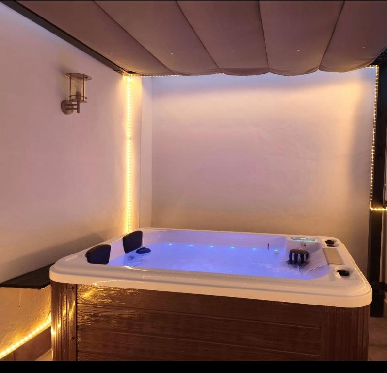 a large bath tub with lights in a bathroom at Los Titos in Arriate