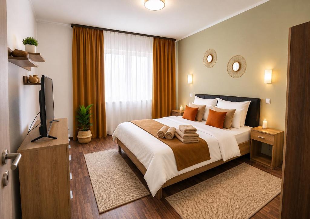 a bedroom with a large bed and a television at Ama Residence 1 in Deva