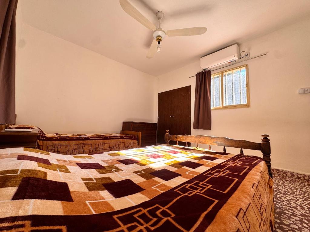 a bedroom with two beds and a ceiling fan at Don Luis Alberto in El Puesto