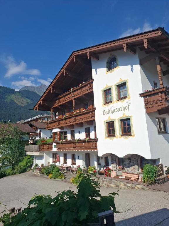 a large white building with a sign on it at Balthasarhof, Haus in Finkenberg