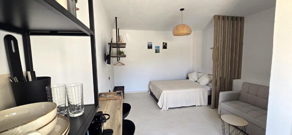 a small room with a bed and a couch at Syros Blue Lagoon G2 in Galissas