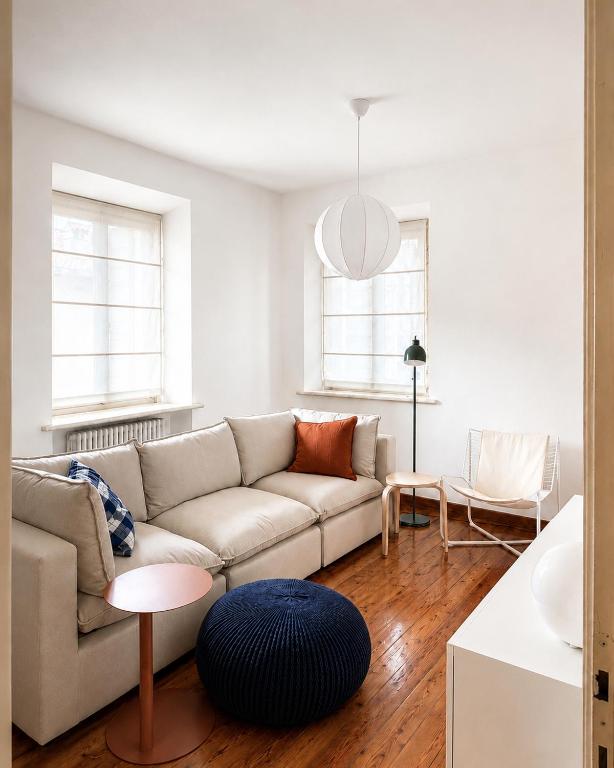 a living room with a couch and a table at Venzone dalla Finestra in Venzone