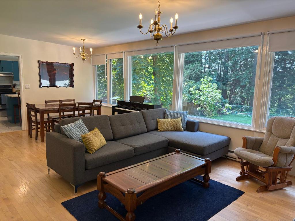 a living room with a couch and a coffee table at Bright and Spacious Upper Level House, Great Area in North Vancouver