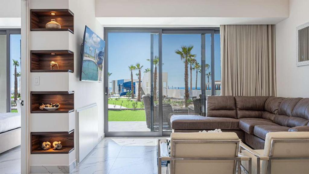a living room with a couch and a table at Encantame Soleil Ground Floor Getaway in Playa Encanto