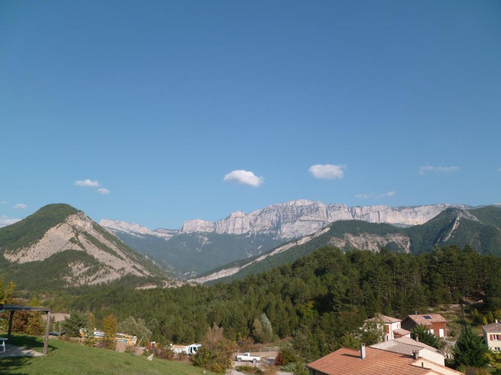 a view of the mountains with houses and trees at VVF Sud Vercors in Die