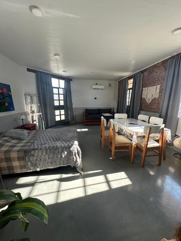 a bedroom with a bed and a table and chairs at Apartamento El Rancho in San Pedro