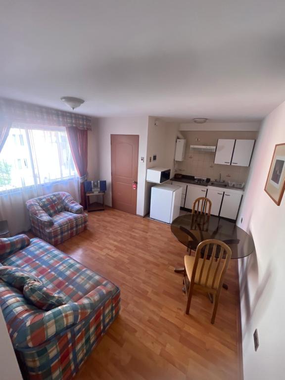 a living room with a couch and a table at DUNA Apart Hotel in Copiapó