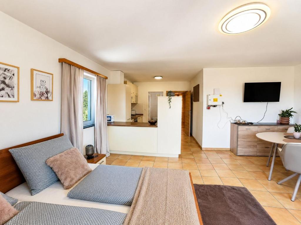 a living room with a couch and a kitchen at Faraway Homes Studios Eberstalzell in Eberstalzell