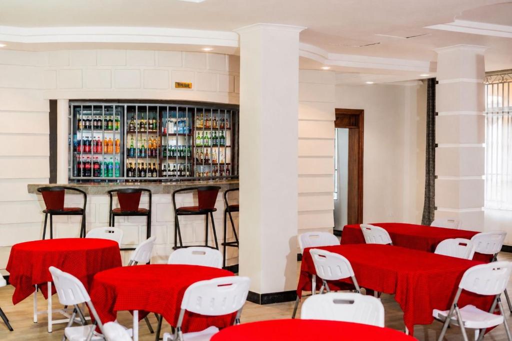 a room with red and white tables and chairs at Kitobo Serenity Resort in Arusha