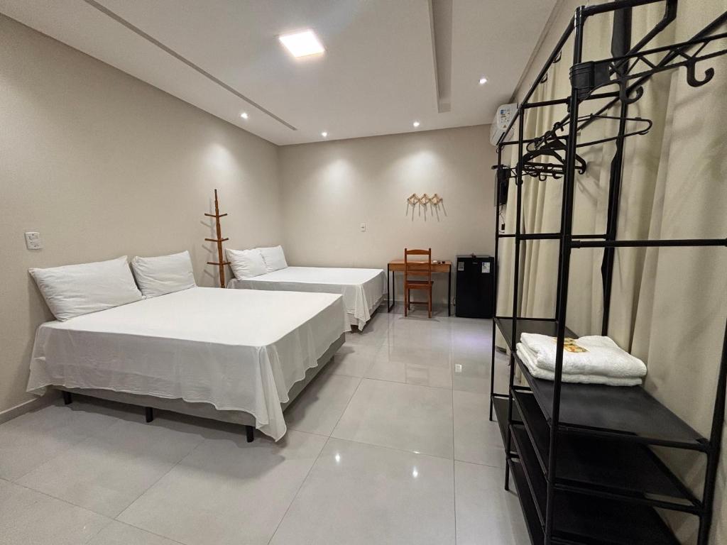 a room with two beds and a ladder in it at Pousada Lua Bela in Piranhas