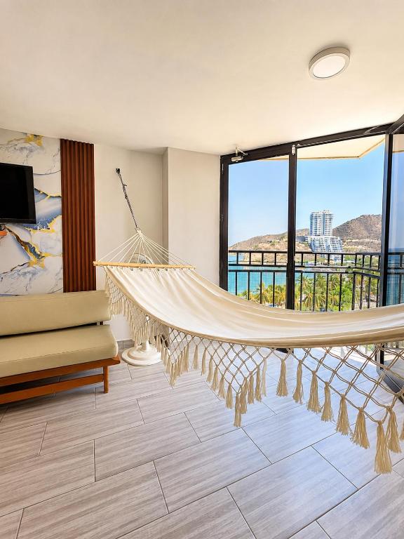 a hammock in a living room with a view at Apartamento 10c Edf.Playa in Santa Marta