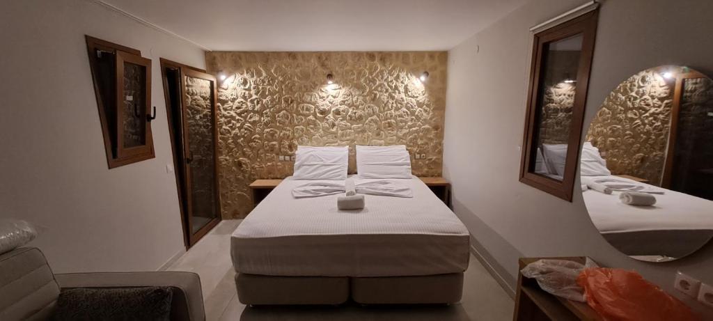 a small room with a bed and a mirror at Calm And Nature in Petra