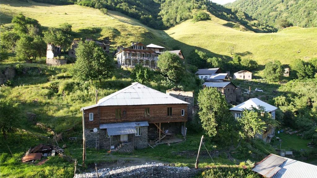 an aerial view of a house on a mountain at Guest House DEDA TINA in Mestia