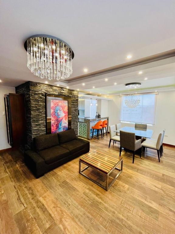 a living room with a couch and a dining room at Luxury Duplex Terrace and Grill in Ica